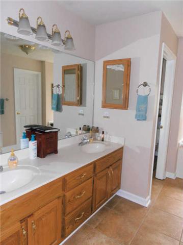 1015 Anderson Road Dickson, TN 37055 - Photo 11 of 20 a bathroom with a double vanity sink and a mirror