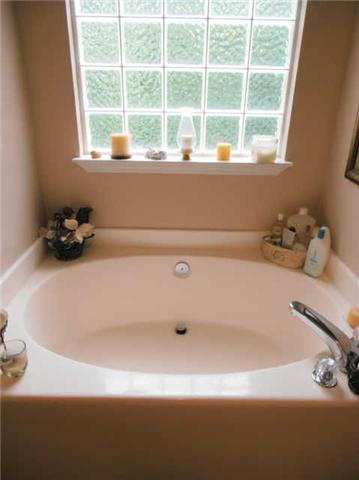 1015 Anderson Road Dickson, TN 37055 - Photo 14 of 20 a bathroom with a tub a sink and a window