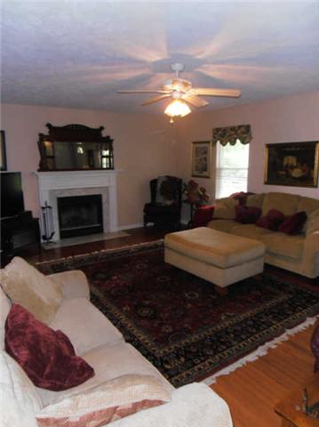 1015 Anderson Road Dickson, TN 37055 - Photo 3 of 20 a living room with furniture a fireplace and a flat screen tv