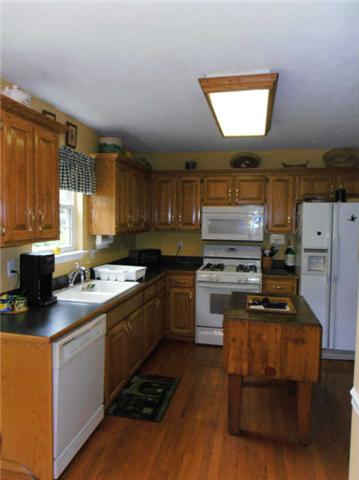 1015 Anderson Road Dickson, TN 37055 - Photo 9 of 20 a kitchen with a stove a sink and a refrigerator