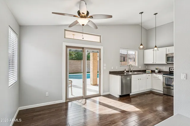 a kitchen with stainless steel appliances granite countertop a stove a refrigerator and a sink