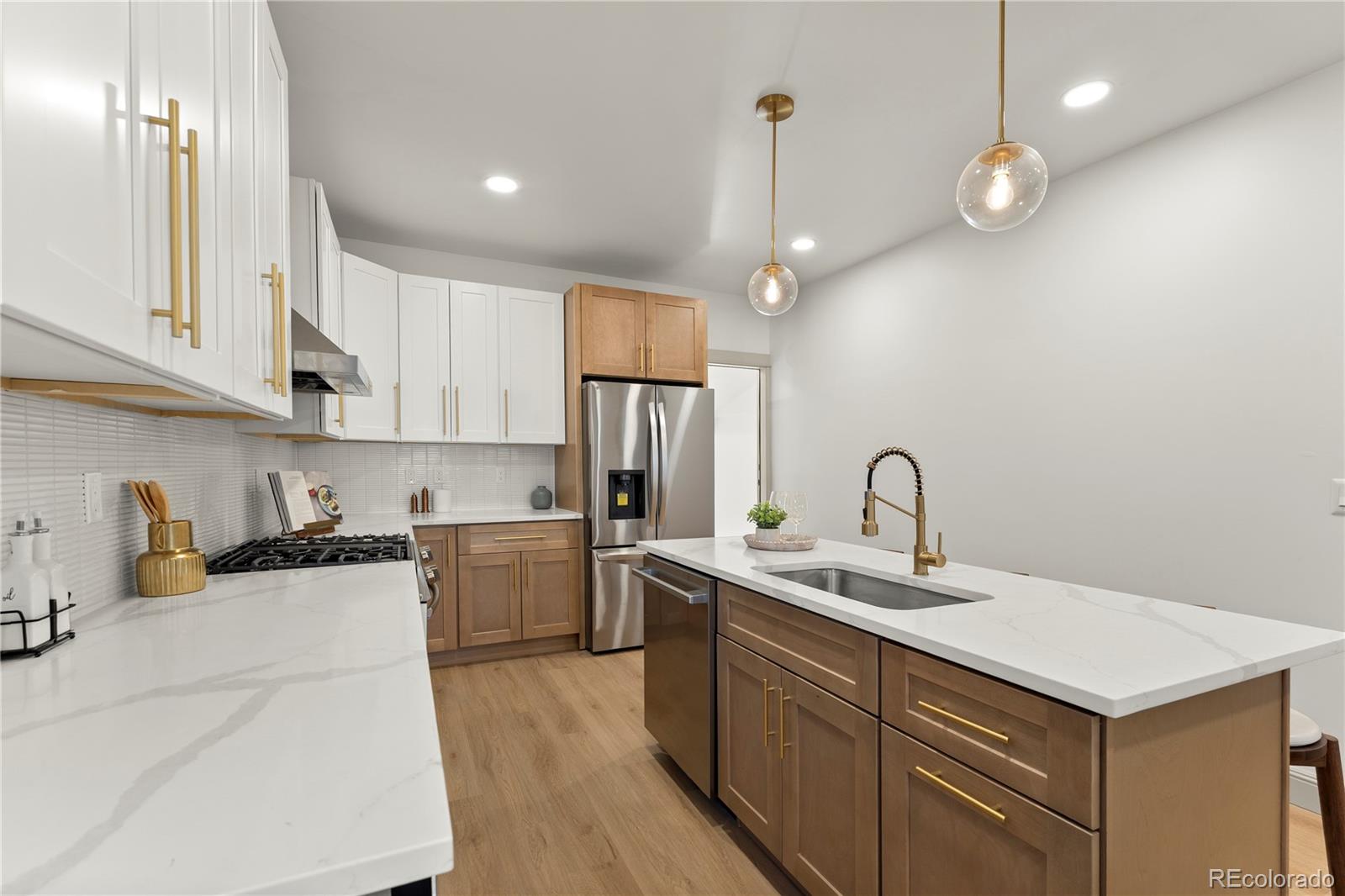 2963 South Lincoln Street Englewood, CO 80113 - Photo 12 of 50 a kitchen with a sink a stove and cabinets