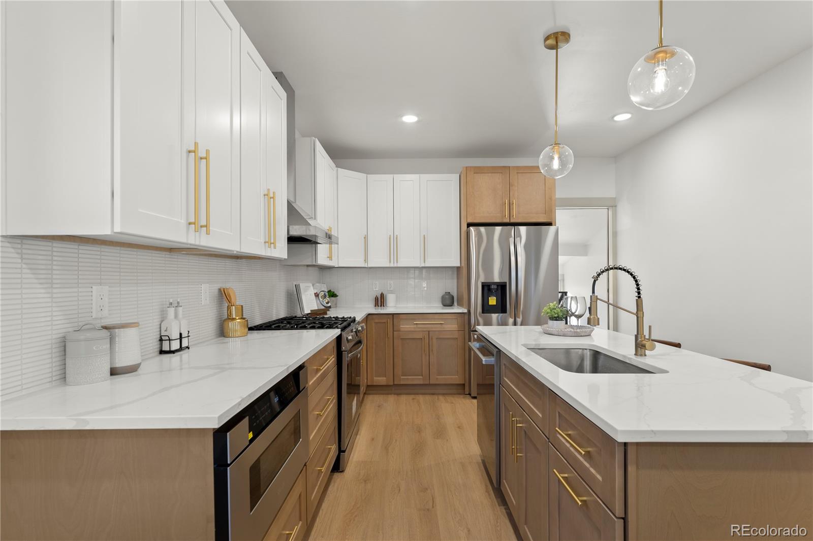 2963 South Lincoln Street Englewood, CO 80113 - Photo 13 of 50 a kitchen with a sink dishwasher a stove top oven a refrigerator with wooden cabinets and floor