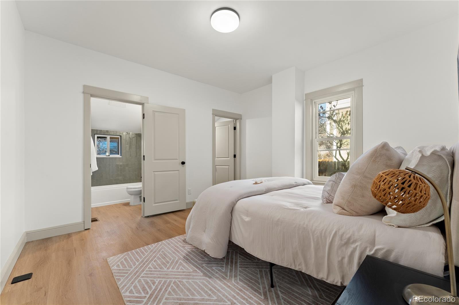2963 South Lincoln Street Englewood, CO 80113 - Photo 14 of 50 a bedroom with a bed and closet with mirror