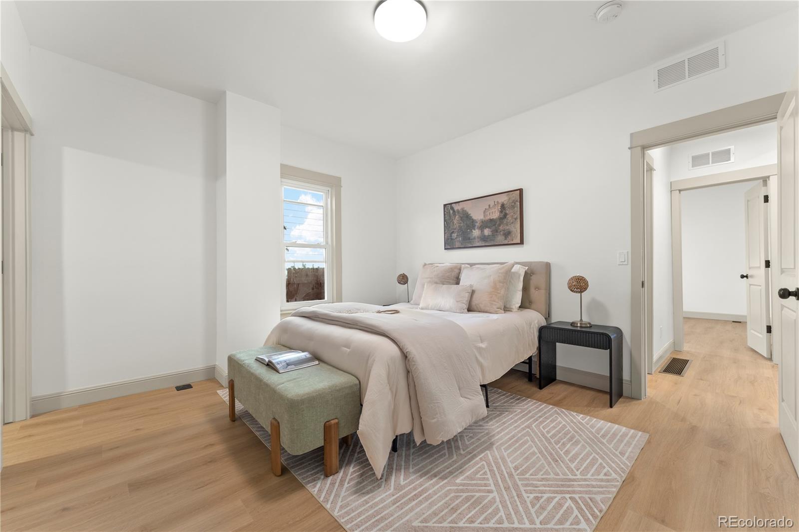 2963 South Lincoln Street Englewood, CO 80113 - Photo 15 of 50 a bed room with a bed and a lamp