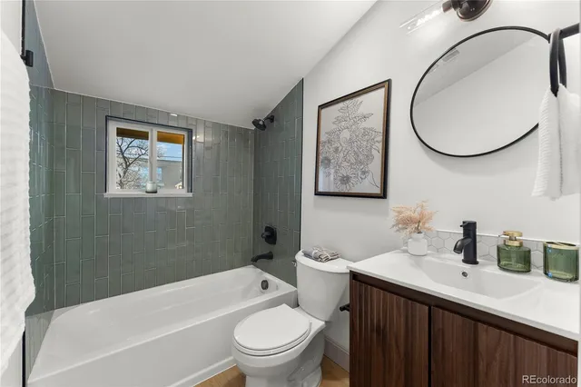 a bathroom with a sink a mirror a toilet and a bathtub