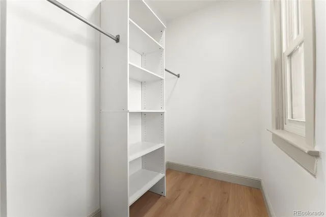a view of walk in closet with empty racks