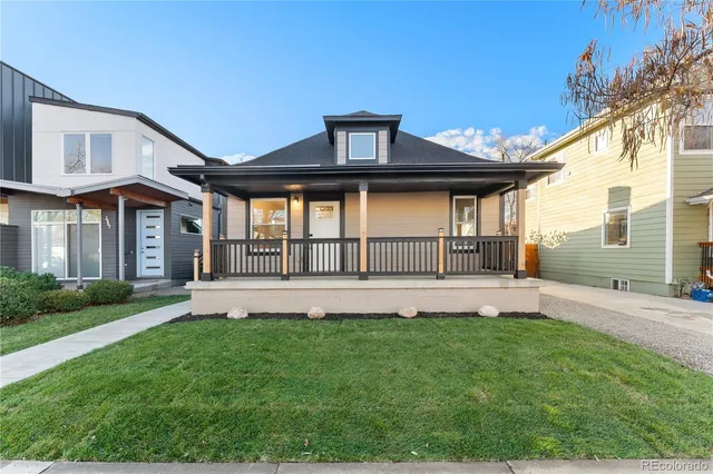 a front view of a house with a yard and garden
