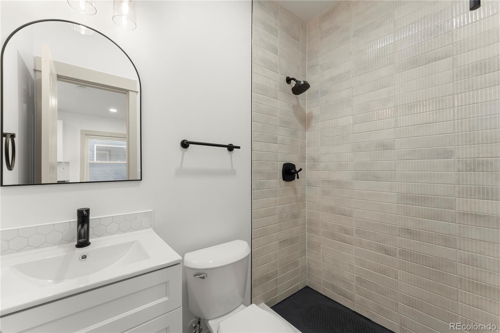 2963 South Lincoln Street Englewood, CO 80113 - Photo 21 of 50 a bathroom with a sink a toilet and shower