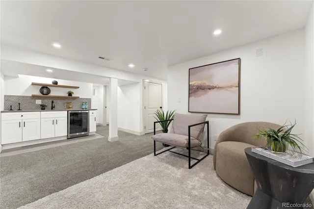 a living room with furniture and a kitchen