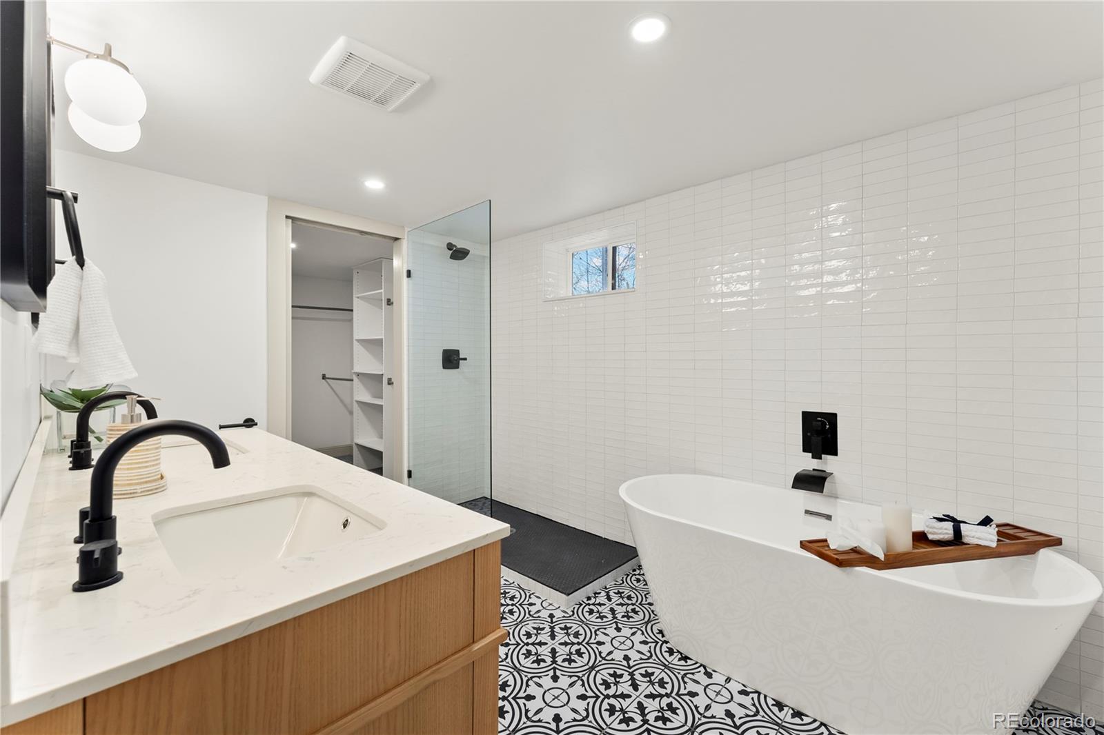 2963 South Lincoln Street Englewood, CO 80113 - Photo 27 of 50 a bathroom with a bathtub sink and mirror