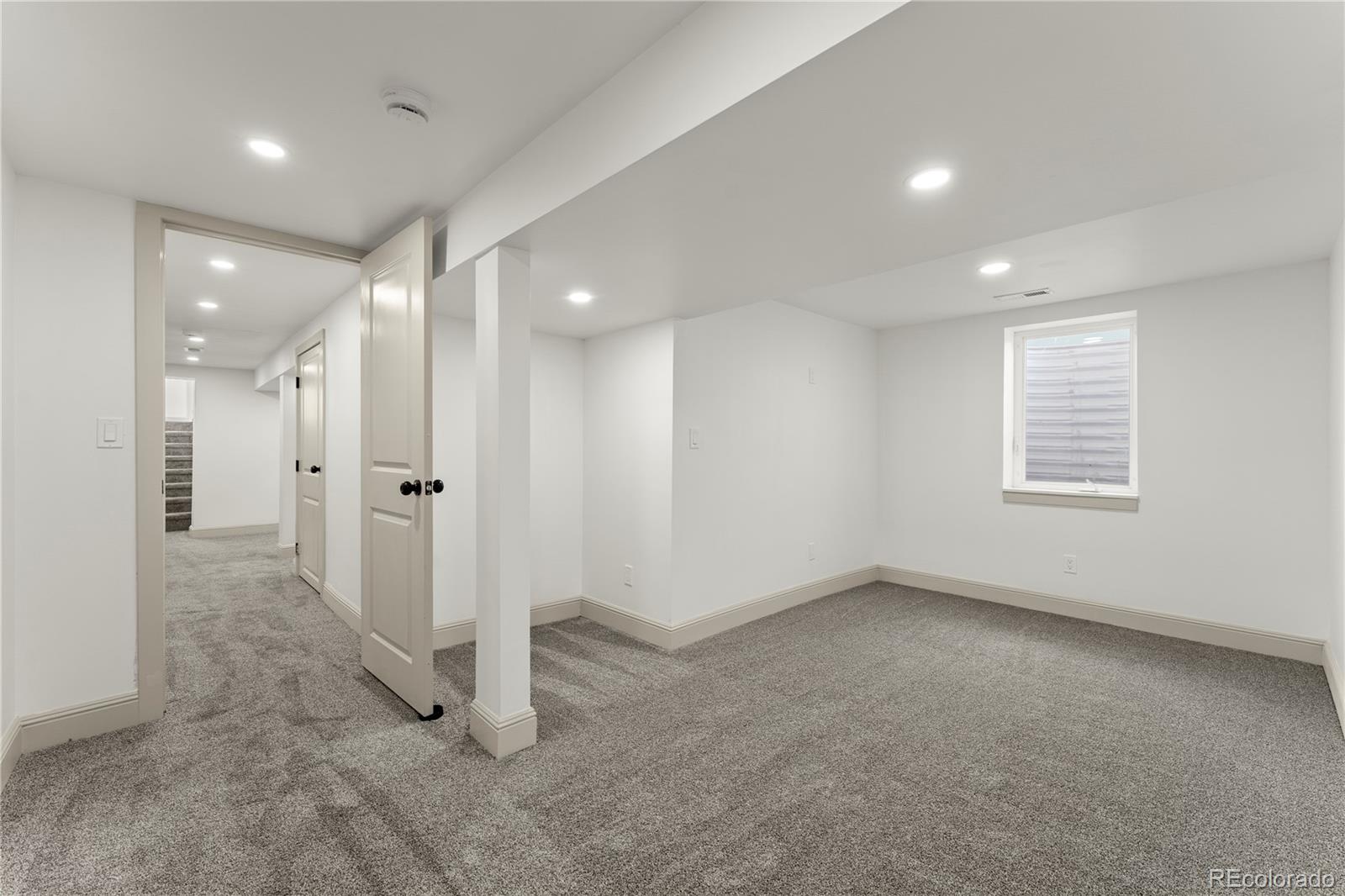 2963 South Lincoln Street Englewood, CO 80113 - Photo 30 of 50 an empty room with windows and pillars in it