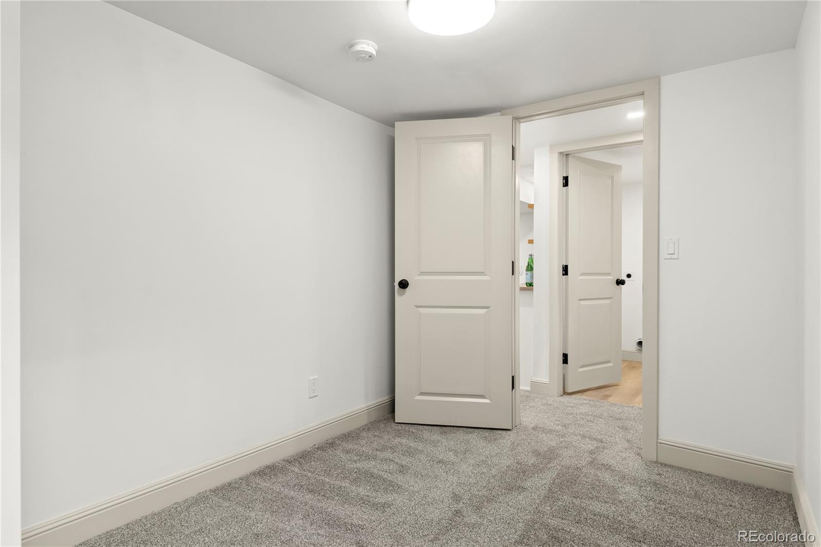 2963 South Lincoln Street Englewood, CO 80113 - Photo 34 of 50 an empty room with white cabinet and mirror