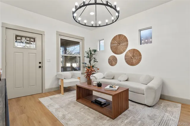a living room with couches a rug and a clock