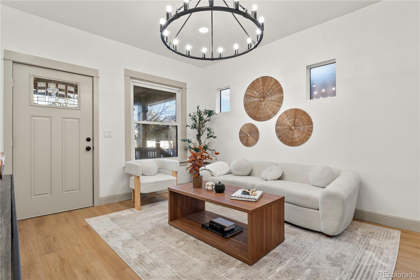 2963 South Lincoln Street Englewood, CO 80113 - Photo 7 of 50 a living room with couches a rug and a clock