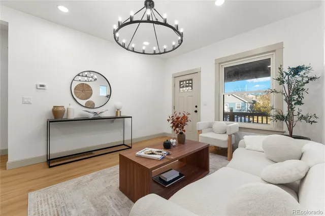 a living room with furniture a rug and a large window
