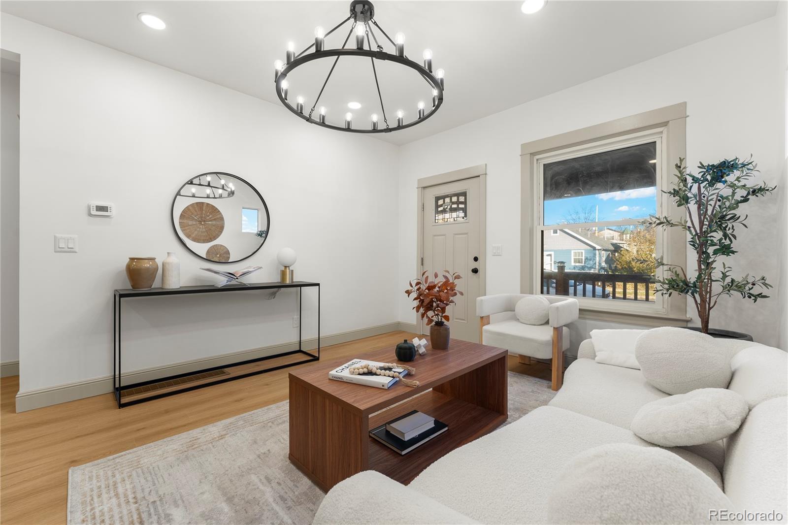 2963 South Lincoln Street Englewood, CO 80113 - Photo 8 of 50 a living room with furniture a rug and a large window