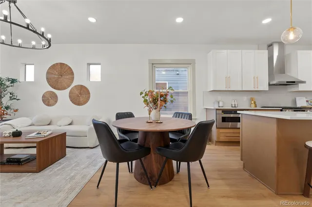 a view of kitchen with cabinets table and chairs