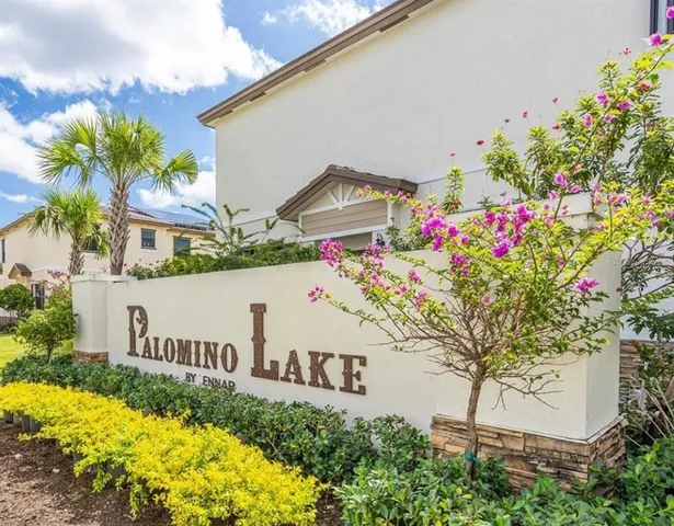 a front view of a house with a yard and fountain