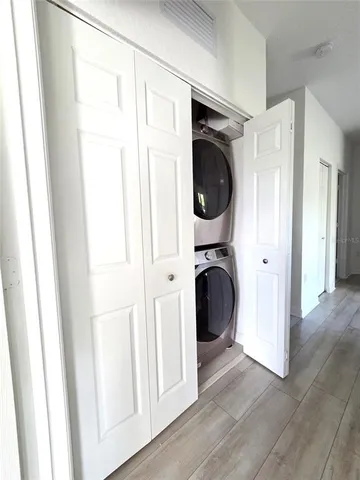 a view of a hallway with washer and dryer