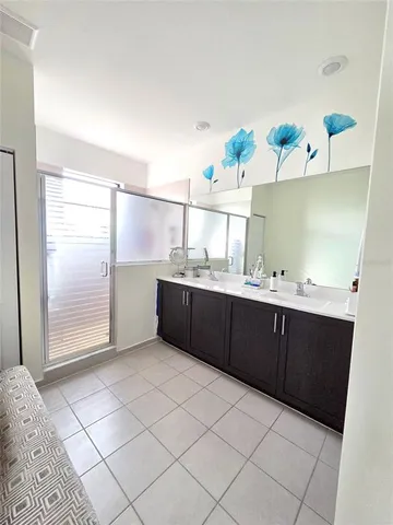 a bathroom with a sink vanity and mirror