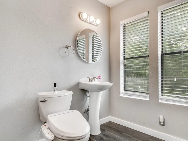 a white toilet sitting next to a bathroom sink
