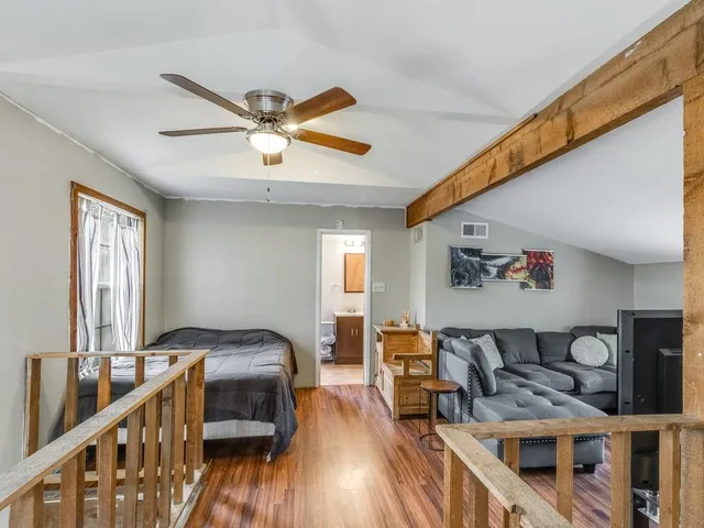 a bedroom with furniture and a wooden floor