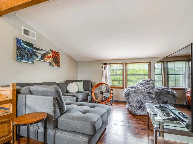 a living room with furniture and a large window