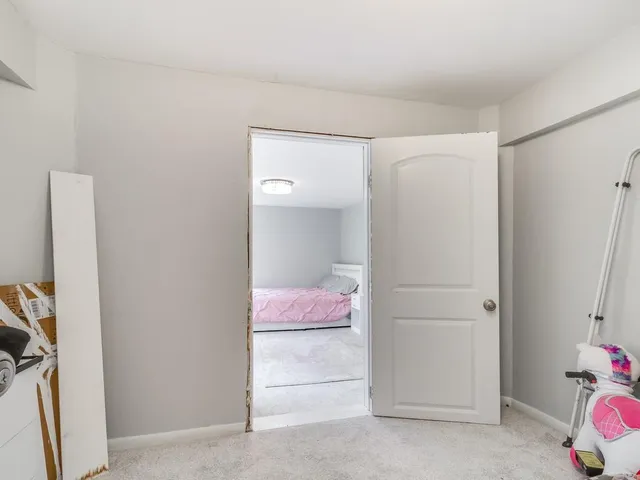 a hallway with a bed and a window
