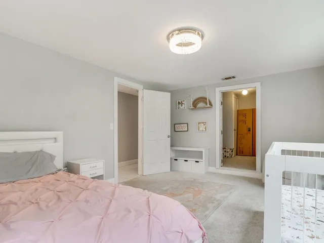 a bedroom with a bed and a view of bathroom