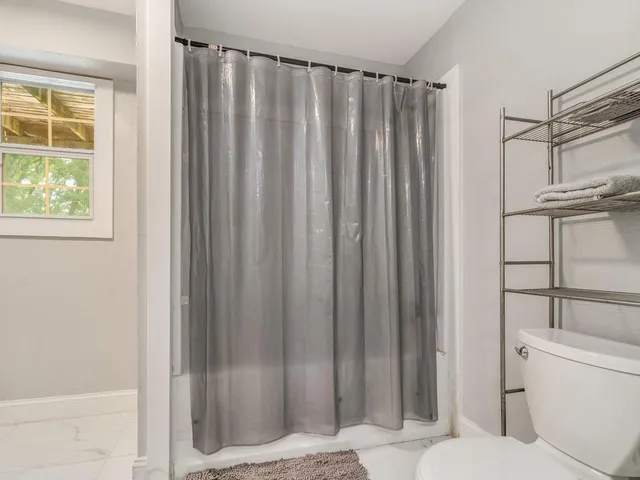 a bathroom with a shower curtain and sink