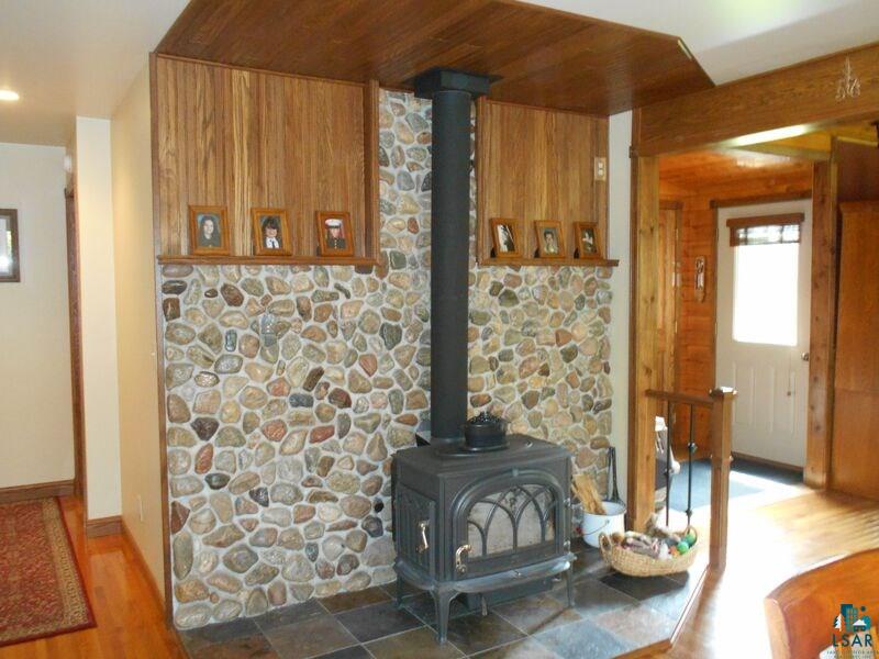 2783 Clark Road Two Harbors, MN 55616 - Photo 10 of 24 Stove with stone wlall