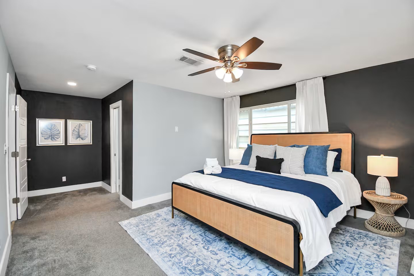 3318 Wichita Street Houston, TX 77004 - Photo 13 of 36 a bedroom with a large bed and a chandelier