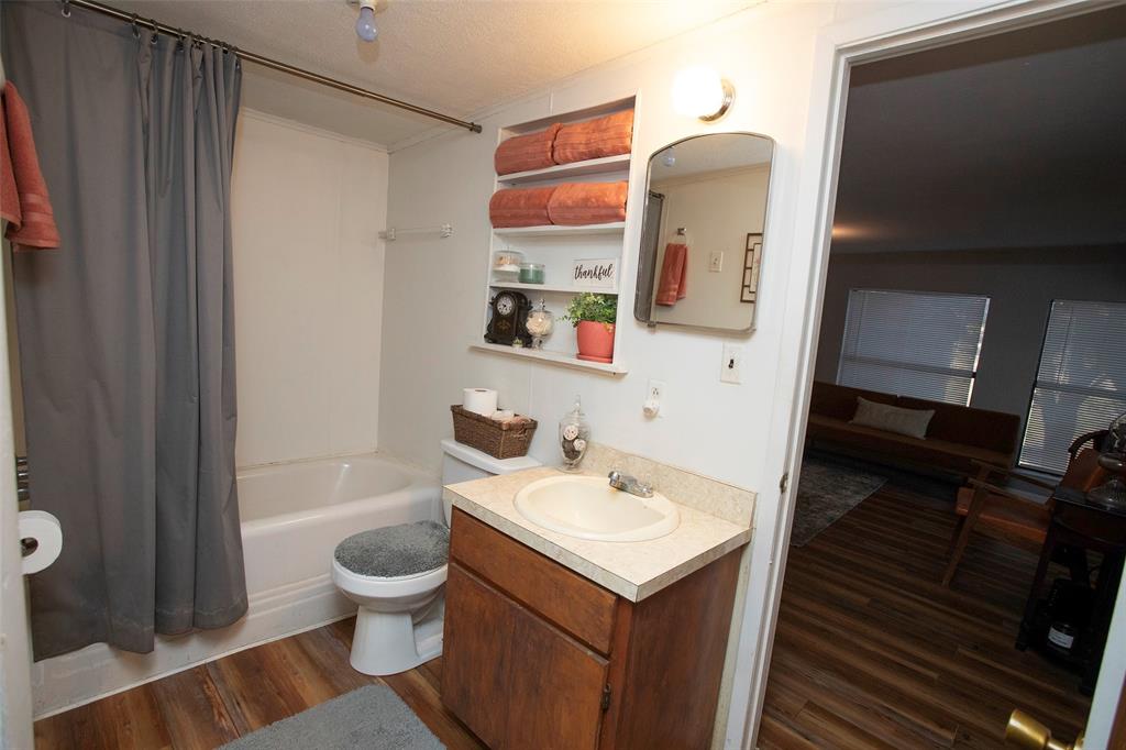 9051 Lacy Road Graford, TX 76449 - Photo 15 of 23 a bathroom with a sink and a mirror