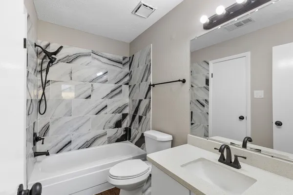 a bathroom with a toilet sink and shower