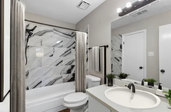 a bathroom with a sink toilet and shower