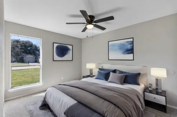 a bedroom with a bed and a window