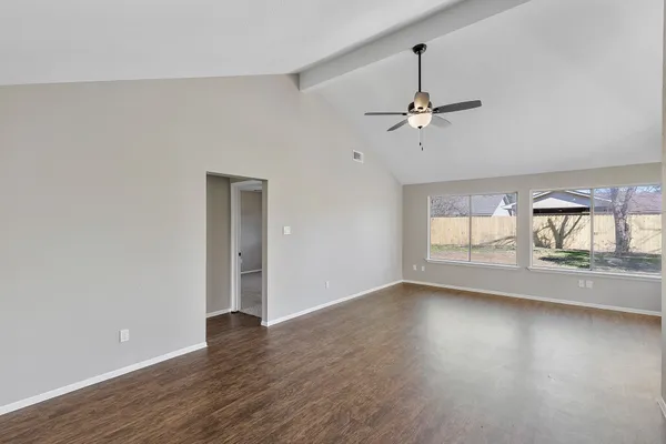 wooden floor in an empty room with a window