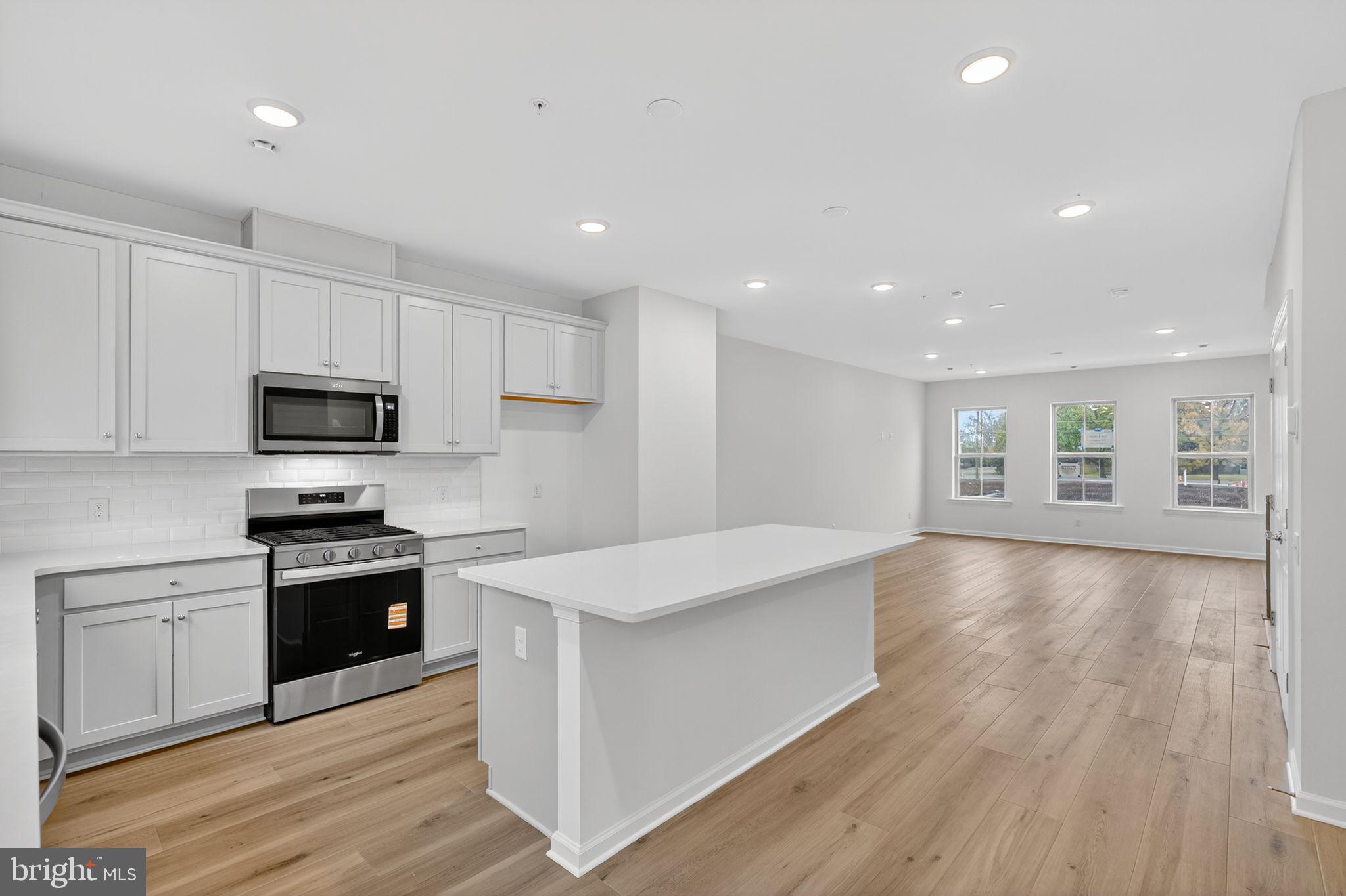 103 Beacon Court, Unit 10102 Lansdale, PA 19446 - Photo 11 of 17 a large kitchen with stainless steel appliances granite countertop a stove a sink and a refrigerator