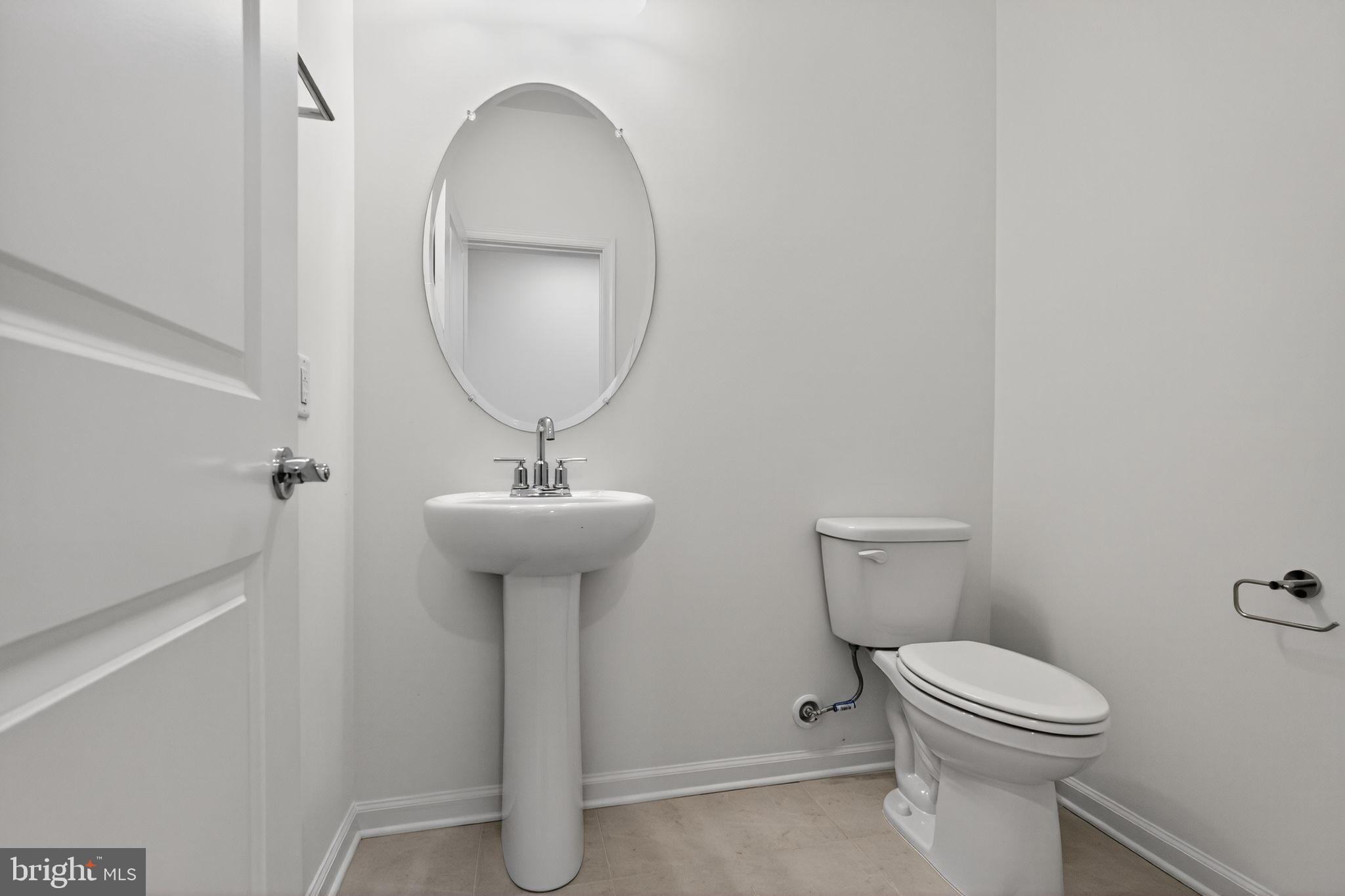 103 Beacon Court, Unit 10102 Lansdale, PA 19446 - Photo 13 of 17 a bathroom with a toilet a sink and a mirror