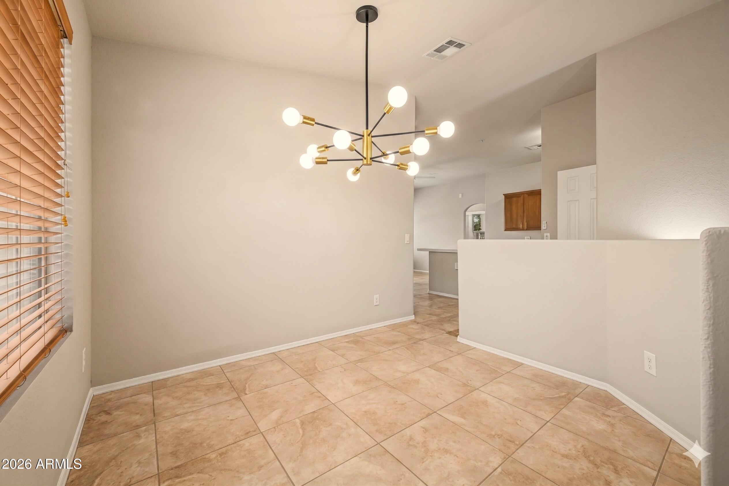 2725 East Mine Creek Road, Unit 2172 Phoenix, AZ 85024 - Photo 14 of 28 a view of a livingroom with a ceiling fan and window