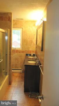 1408 Mt Airy Road Rosedale, MD 21237 - Photo 16 of 22 a view of bathroom with a sink and a mirror