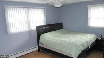 1408 Mt Airy Road Rosedale, MD 21237 - Photo 20 of 22 a large bed sitting in a bedroom next to a window