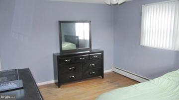 1408 Mt Airy Road Rosedale, MD 21237 - Photo 21 of 22 a room with a bed and a dresser