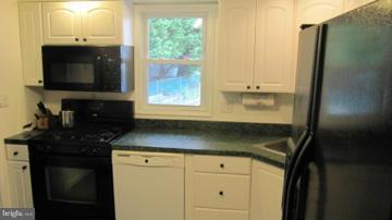 1408 Mt Airy Road Rosedale, MD 21237 - Photo 6 of 22 a kitchen with a sink and a mirror