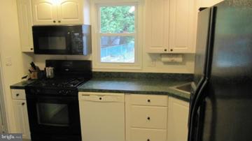 1408 Mt Airy Road Rosedale, MD 21237 - Photo 7 of 22 a kitchen with a sink and a microwave