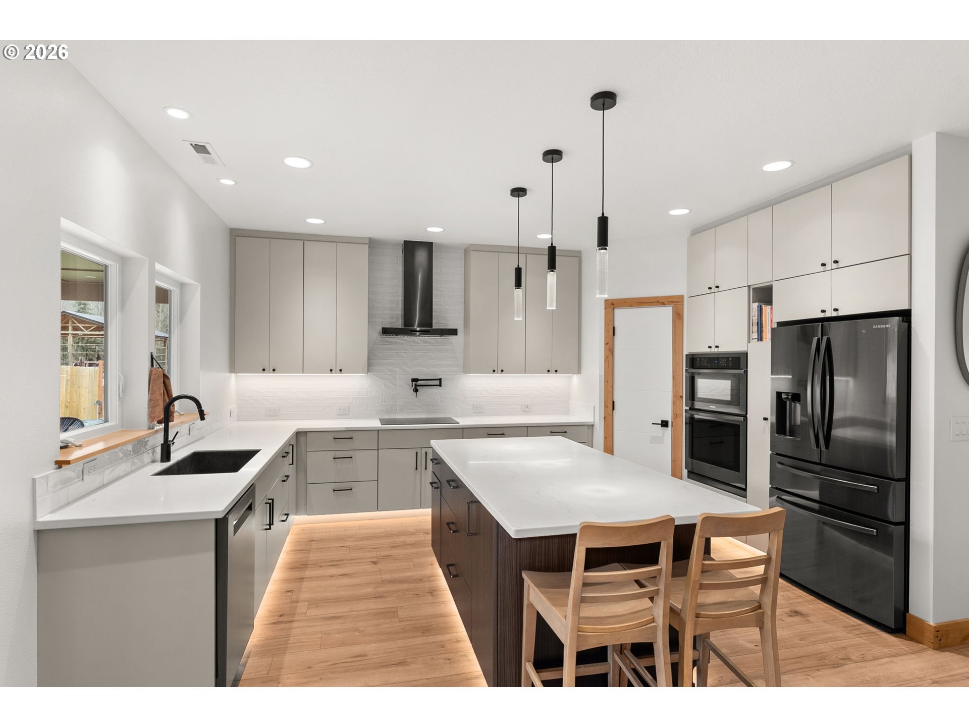 527 Tennessee Road Winlock, WA 98596 - Photo 13 of 48 a kitchen with stainless steel appliances granite countertop a table chairs sink refrigerator and microwave