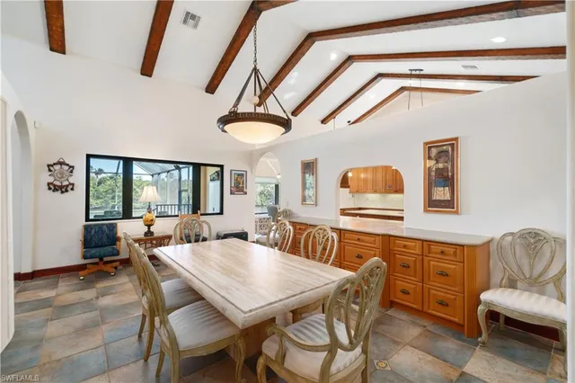 a dining room with furniture and window