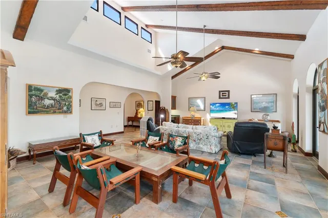 a living room with lots of furniture and view of kitchen