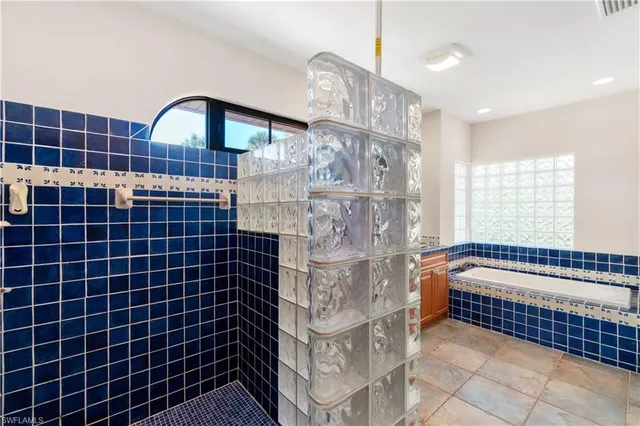 a bathroom with a bathtub and shower